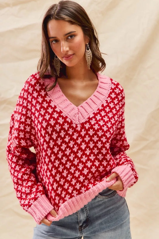 Regular Chloe red pink color block sweater front view with diamond knit pattern.