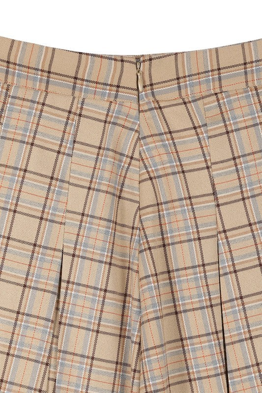 Tailored beige plaid mini skirt with pleats and six pin-tucks on both the front and back. Side zipper with a high waist.