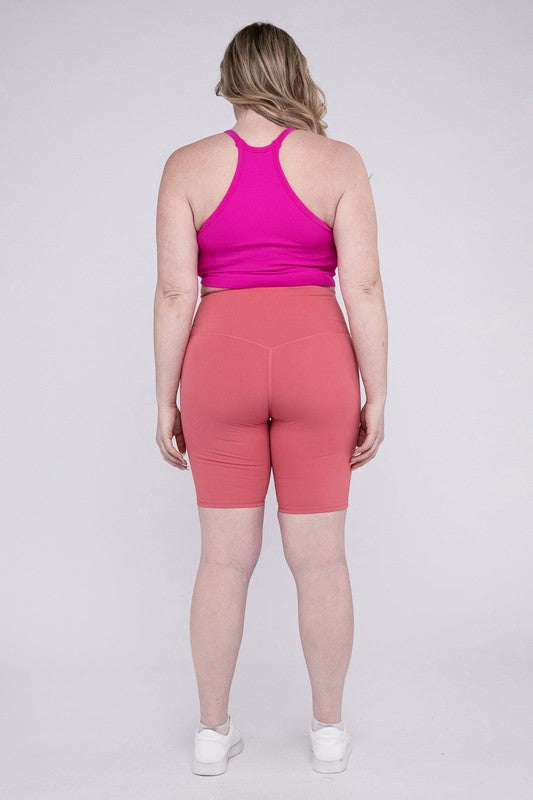 High-rise plus-size athletic biker shorts in desert rose, featuring a fitted silhouette and seamless design for comfort and flexibility.