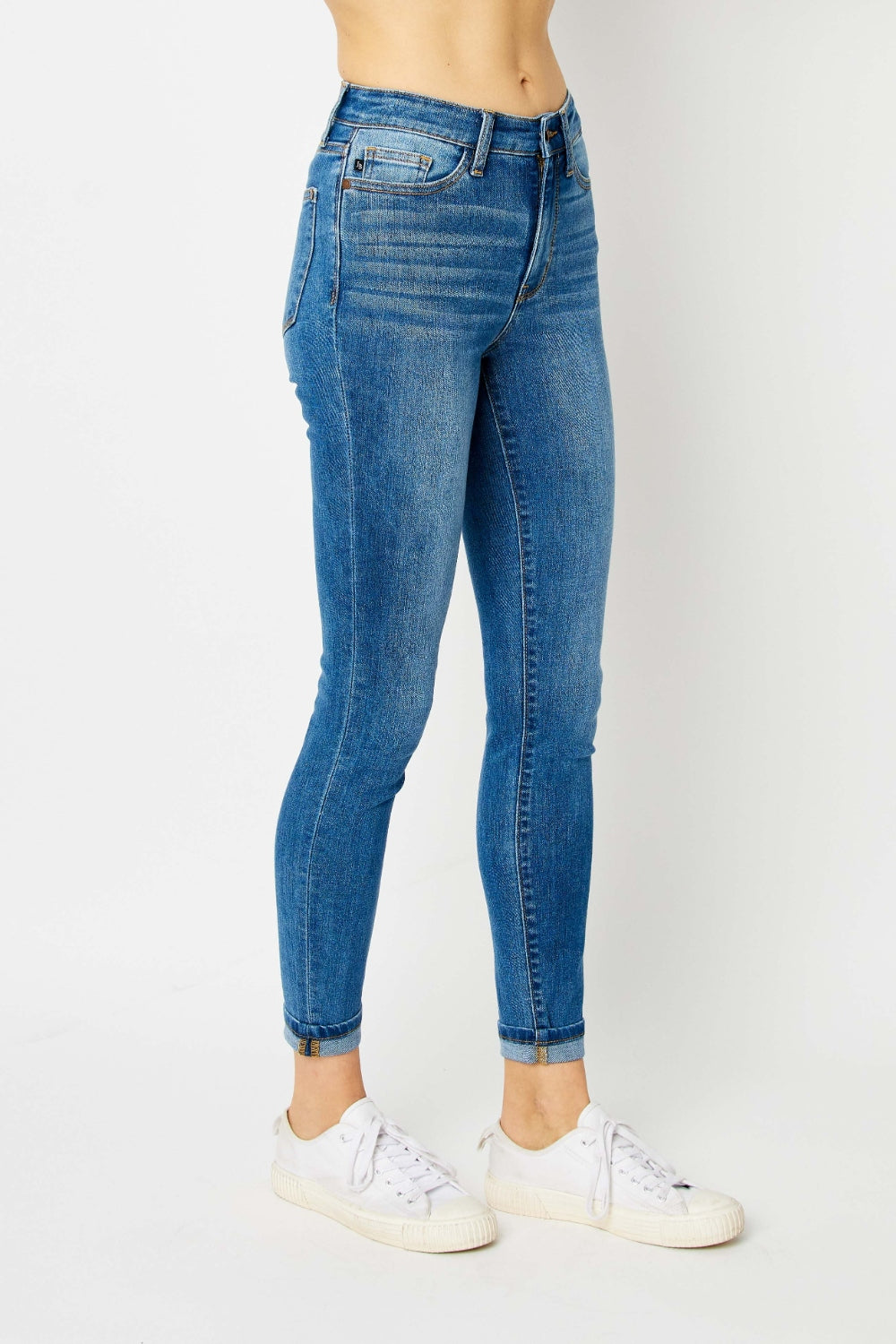 Mid-rise skinny jeans with cuffed hems and a zip fly. Medium wash with a slim fit and highly stretchy fabric.