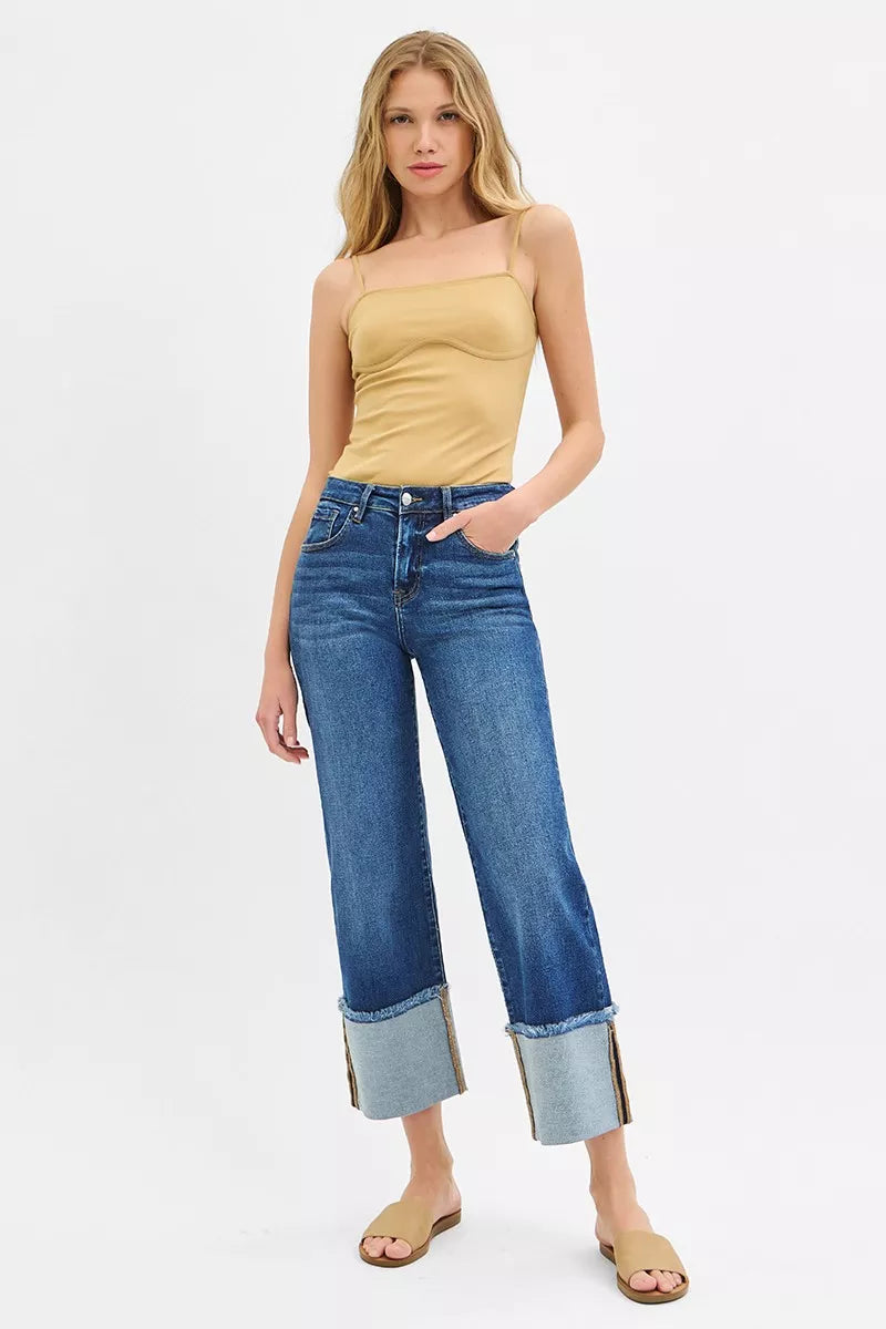 Front angle of Desi Mid Rise Crop Wide Cuffed Jeans paired with top and sandals.