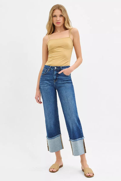 Front angle of Desi Mid Rise Crop Wide Cuffed Jeans paired with top and sandals.