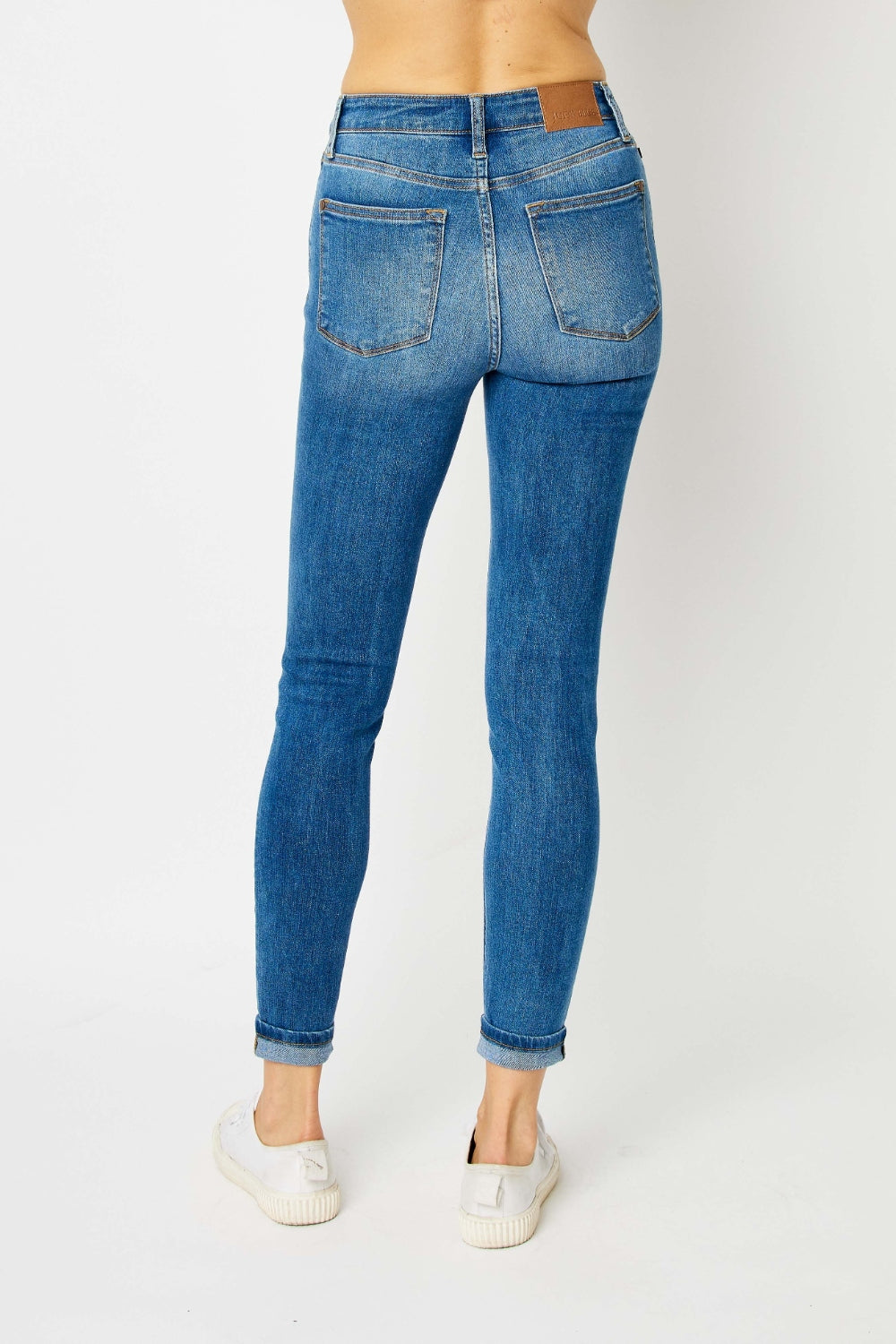 Mid-rise skinny jeans with cuffed hems and a zip fly. Medium wash with a slim fit and highly stretchy fabric.