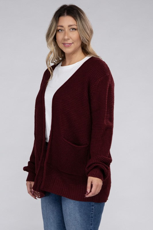 Curvy plus-size waffle-pattern open cardigan sweater in dark burgandy, with long sleeves, oversized fit, and pockets.