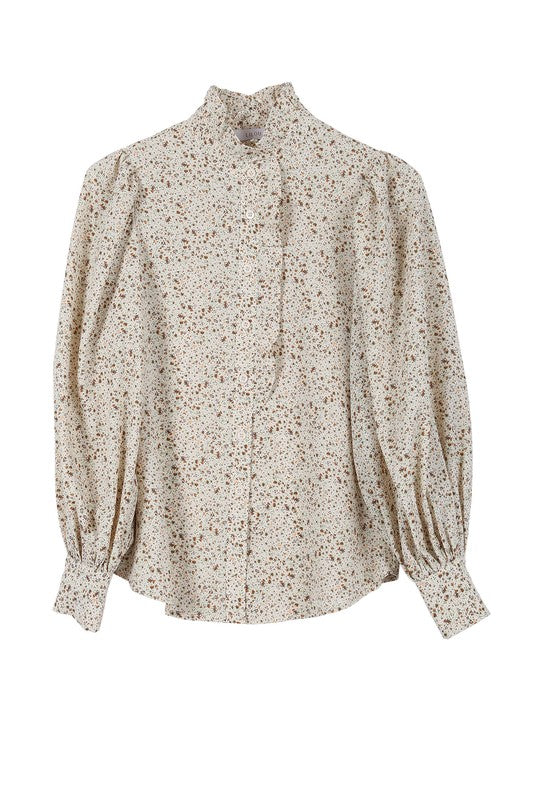 Stand Collar Floral Frill Blouse with puff long sleeves, floral pattern, and ruffled front detailing. Features shirring at the collar, shoulders, and cuffs. Button down closure.