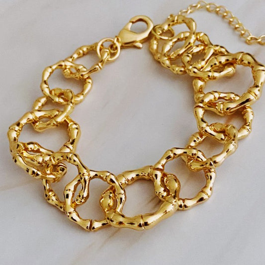 Artfully Linked Chain Bracelet with textured gold links displayed on soft background