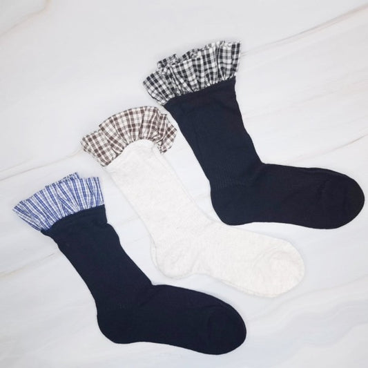 Flat lay of all three Oh So Chic Plaid Ruffle Socks highlighting plaid ruffle trim.