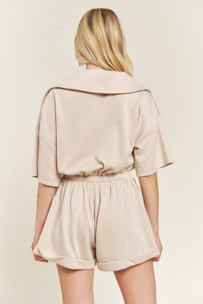 Back of beige Clover Plus Size romper with elastic waistband and relaxed fit.