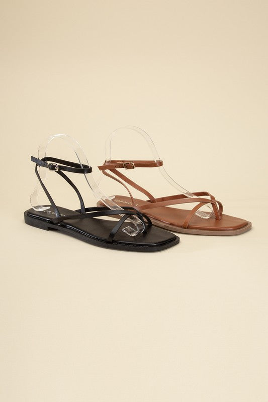 Black and Tan stylish strappy flat sandals with an open toe and square shape.