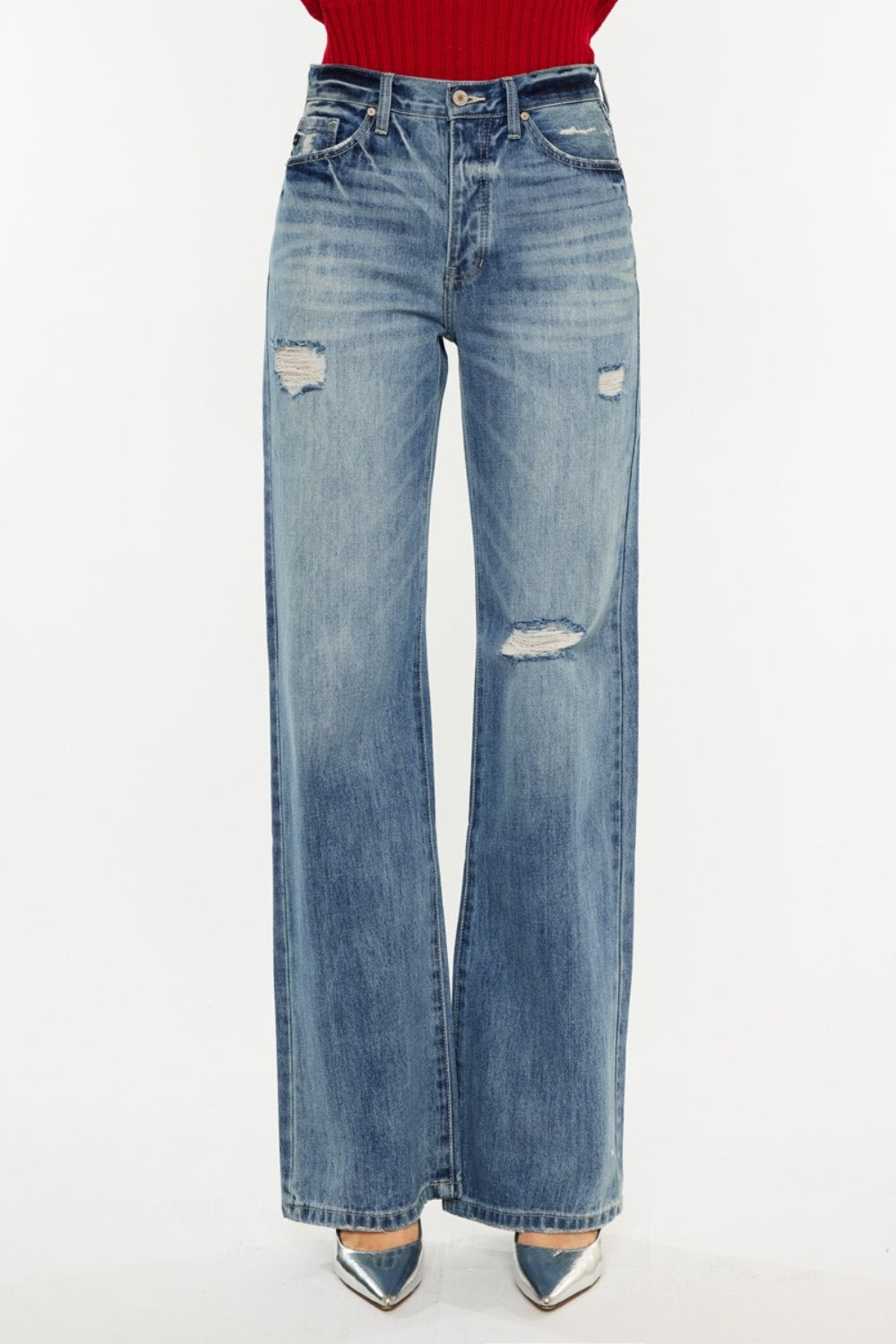 Distressed high-rise bootcut jeans with pockets and a slightly stretchy, washed fabric, offering a retro-chic style.