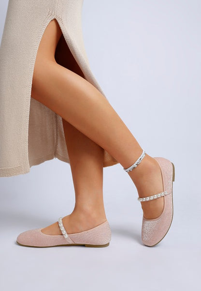 Second side view of pink Corphee Pearl Strapped Glitter Ballerinas being worn, showing strap and sole.