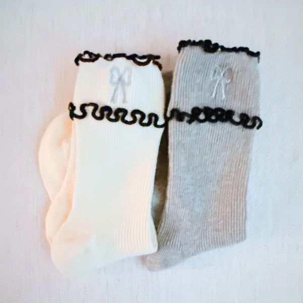 Folded cream and grey Ribbon Ripple Socks showing ripple edge and ribbon detail.