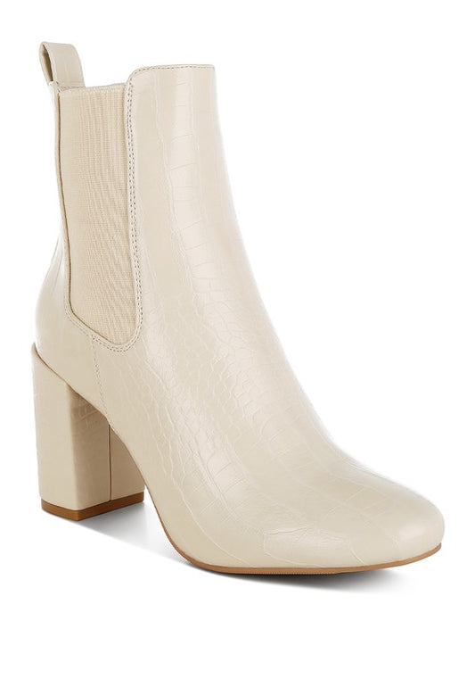 Front angle view of beige Briony Block Heel Ankle Boots in patent vegan leather with round toe.