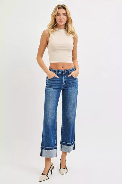Model wearing Vera Mid Rise Straight Jeans with beige sleeveless top and heels.