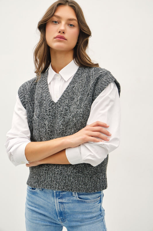 Charcoal cable-knit sweater vest with a V-neckline and cap sleeves.