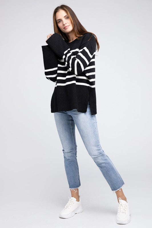 Black oversized sweater with a ribbed hem and striped pattern, featuring a round neckline and long sleeves.