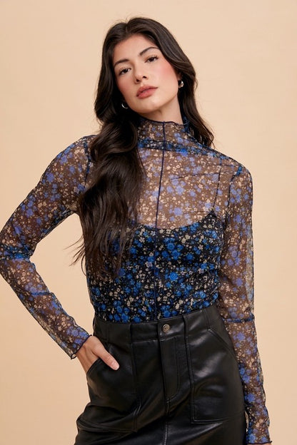 Close front shot of Elodie floral mesh top highlighting delicate sheer fabric and floral pattern.