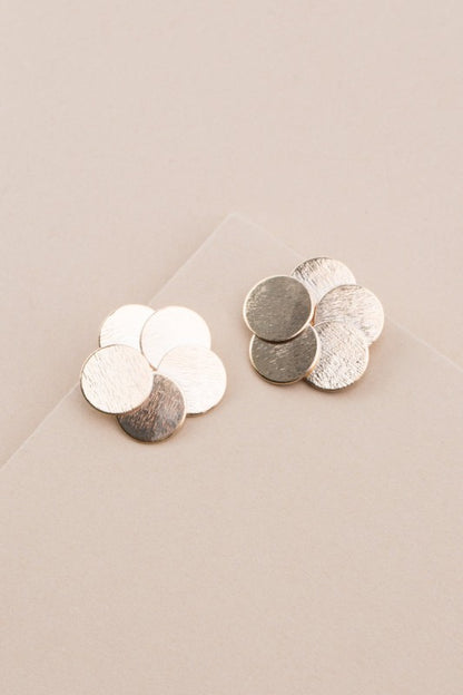 Top view of Round and Round Earrings with overlapping brushed gold discs.