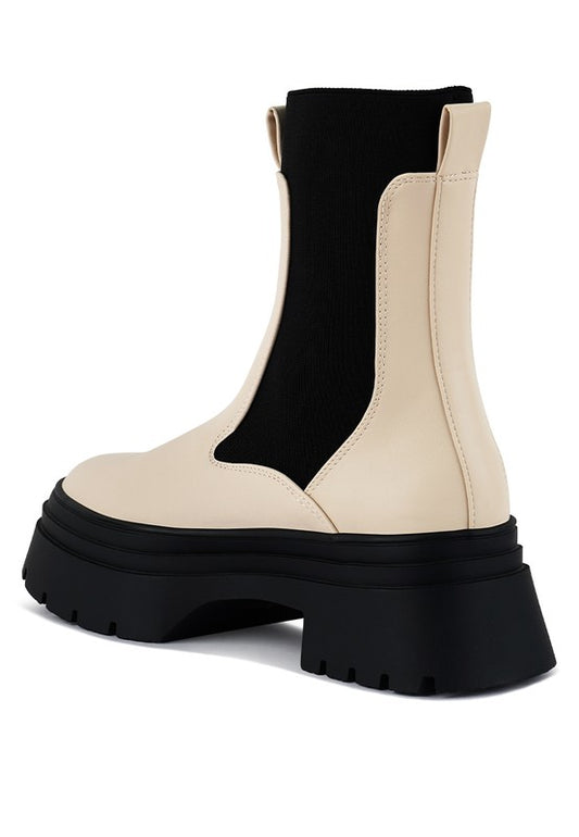 Back angle view of Ronin ecru Chelsea boot with pull tab and chunky heel.