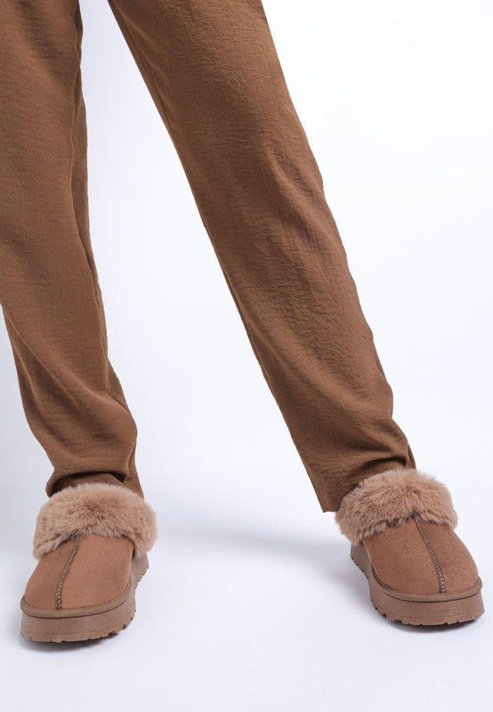 Model styling Brown Portho Faux Fur Slip Ons with lounge pants for everyday comfort.