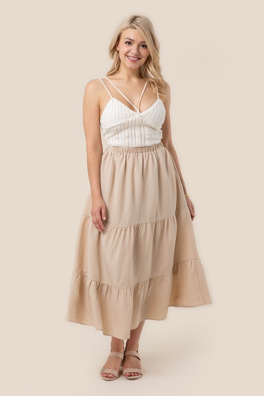 Tiered maxi skirt with elastic waistband in beige. Flowy silhouett, lined for full coverage.