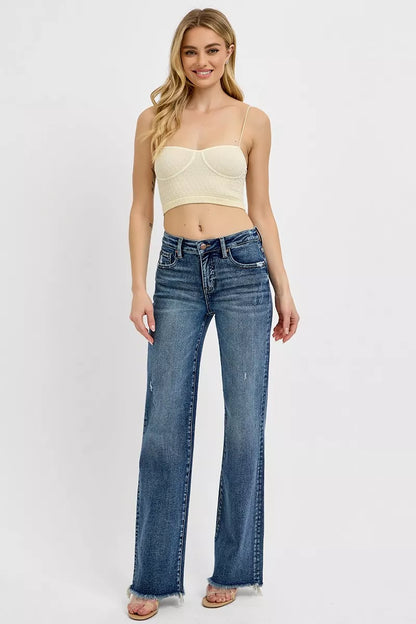 Model in Vivica Tummy Control Jeans, long straight leg fit in dark wash with raw hem and subtle distressing