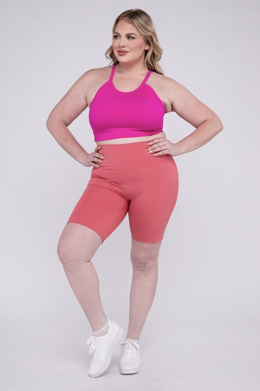 High-rise plus-size athletic biker shorts in desert rose, featuring a fitted silhouette and seamless design for comfort and flexibility.