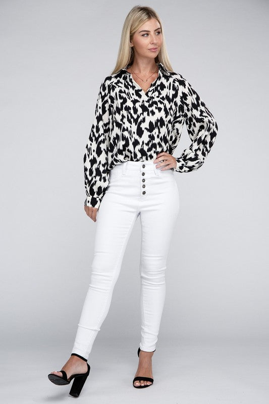 Black and white animal print collared shirt with long sleeves and a relaxed drop-shoulder design.