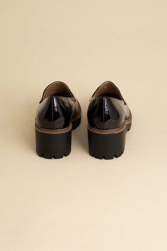 Chunky loafers in black feature a sleek design with a 2.3" heel.