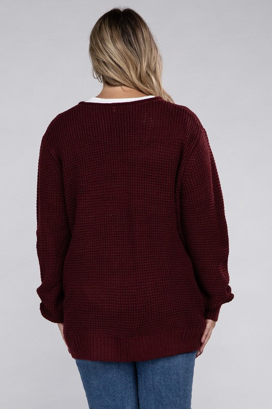 Curvy plus-size waffle-pattern open cardigan sweater in dark burgandy, with long sleeves, oversized fit, and pockets.