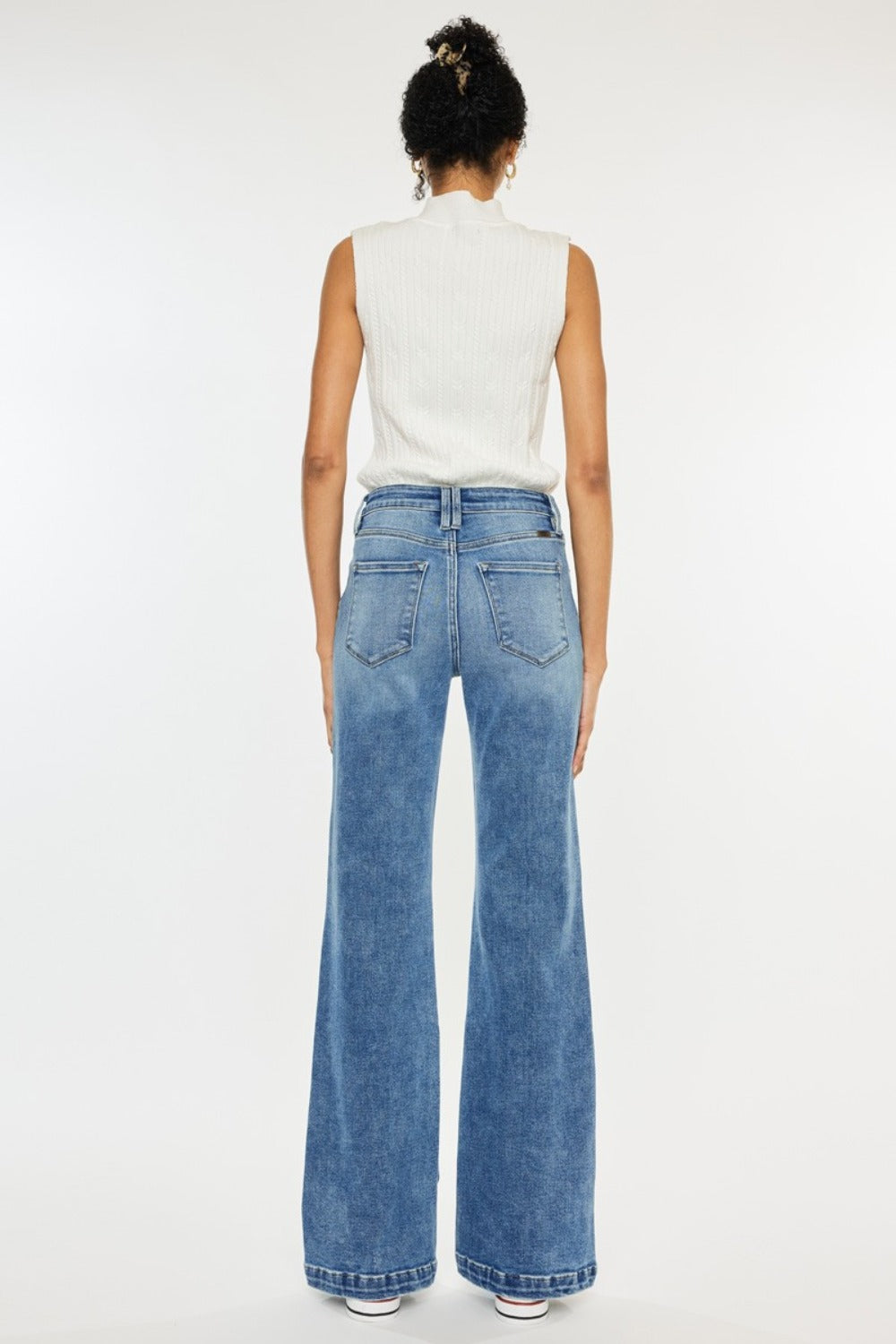 High Rise Wide Leg Jeans in medium wash by Kancan. Slightly stretchy denim with classic 5-pocket design, regular hem, and zipper fly. Versatile wide-leg flare silhouette.