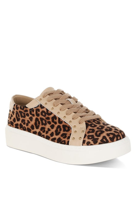 Side angle of beige leopard print sneakers with edgy stud embellishments and 1-inch flatform heel.