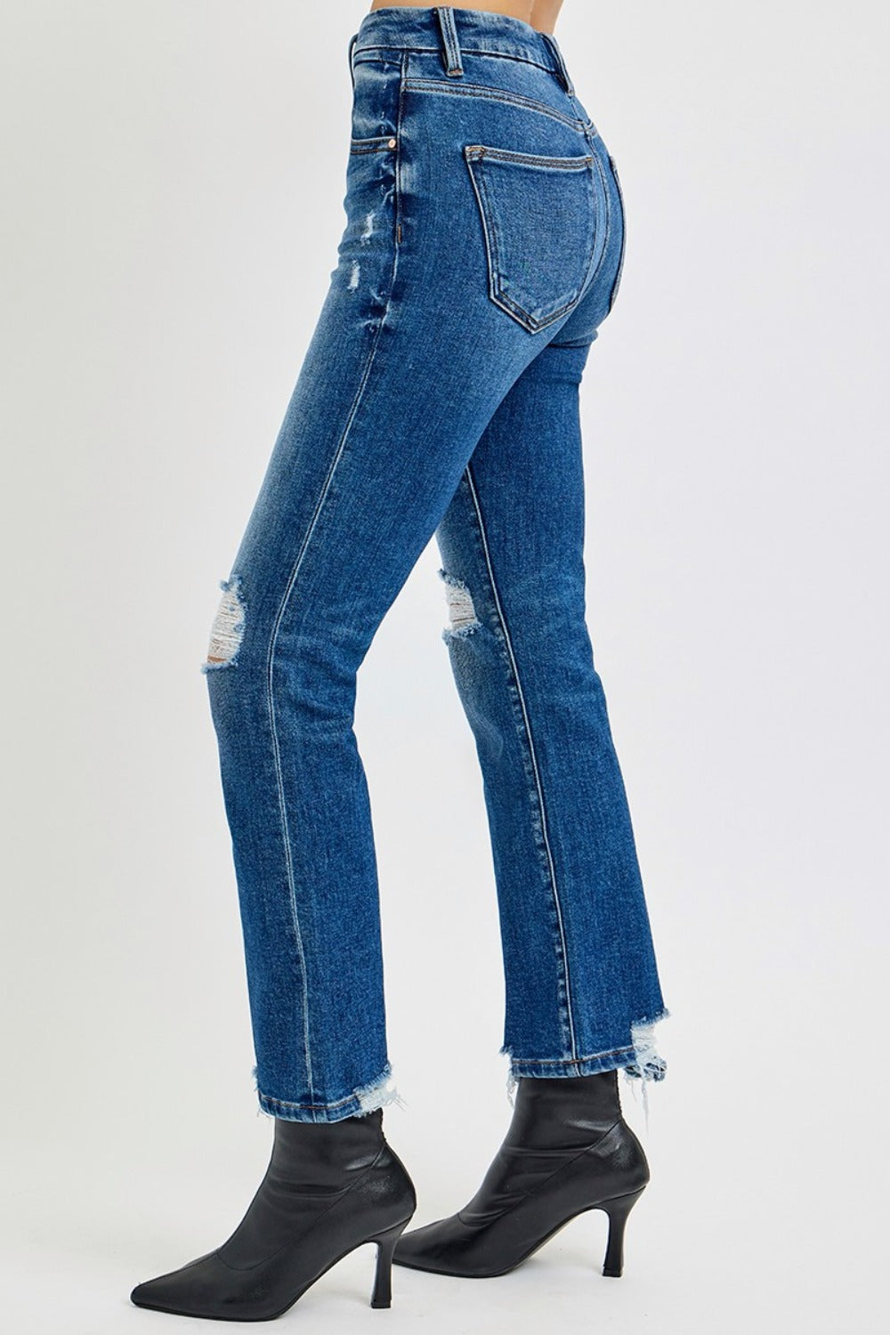 High Rise Distressed Crop Straight Jeans in dark wash with a high-rise fit, distressed details, raw hem, and slightly stretchy fabric for a cool, versatile look.