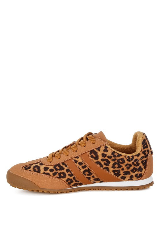 Medial side view of leopard print sneakers with faux leather upper