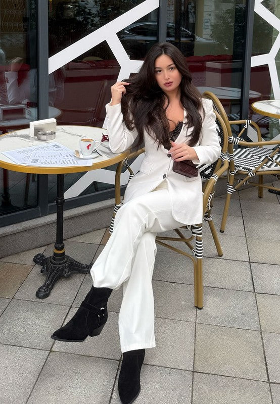 Jockey Harness Ankle Boots black suede lifestyle photo paired with white suit for chic look