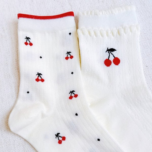 Flat lay of Cherries All Over Sock Set showing both red-trim and white variants.