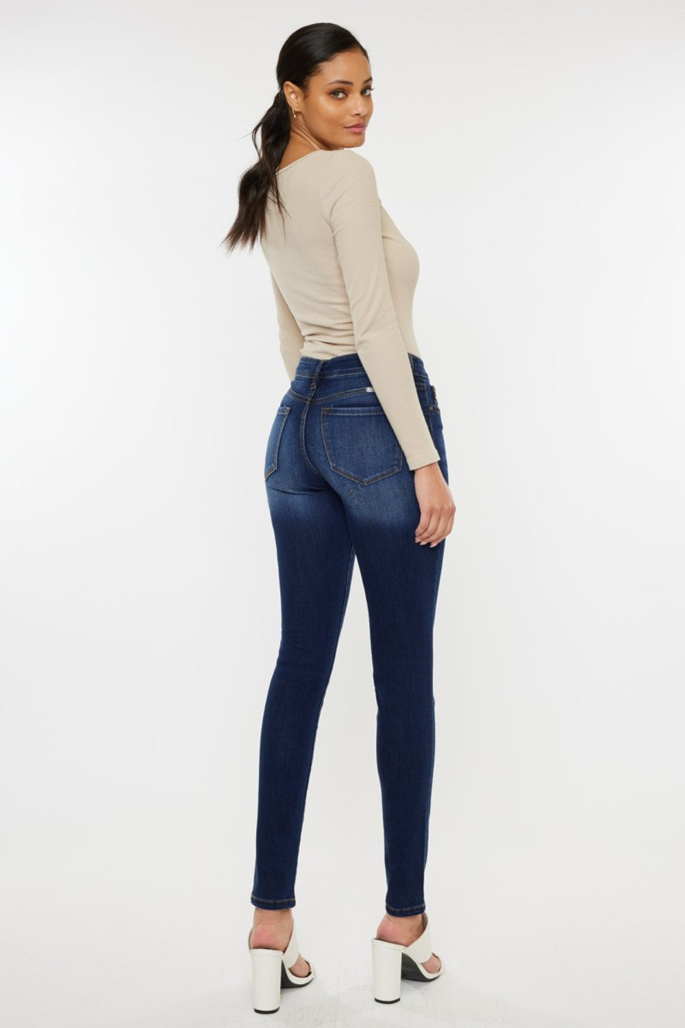 Mid rise gradient skinny jeans with a dark wash. Slightly stretchy, with pockets and a zip fly closure.