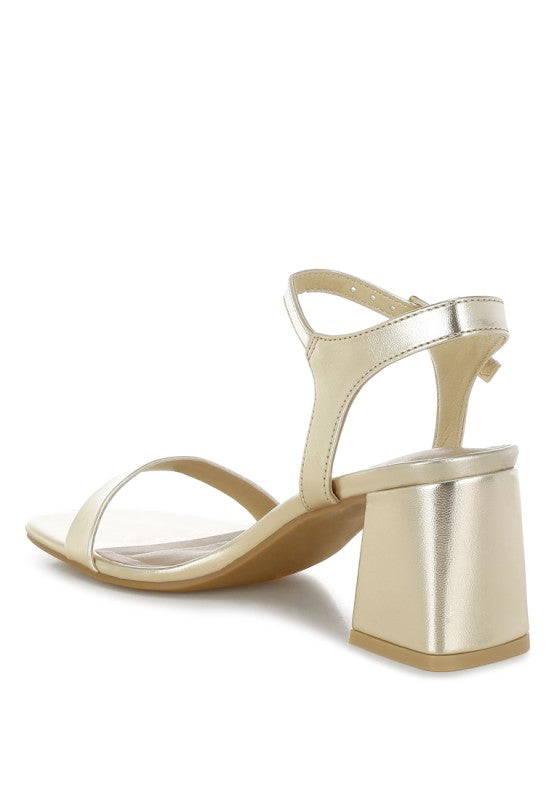 Back angle of Kazara Metallic Block Heels with flared block heel detail.