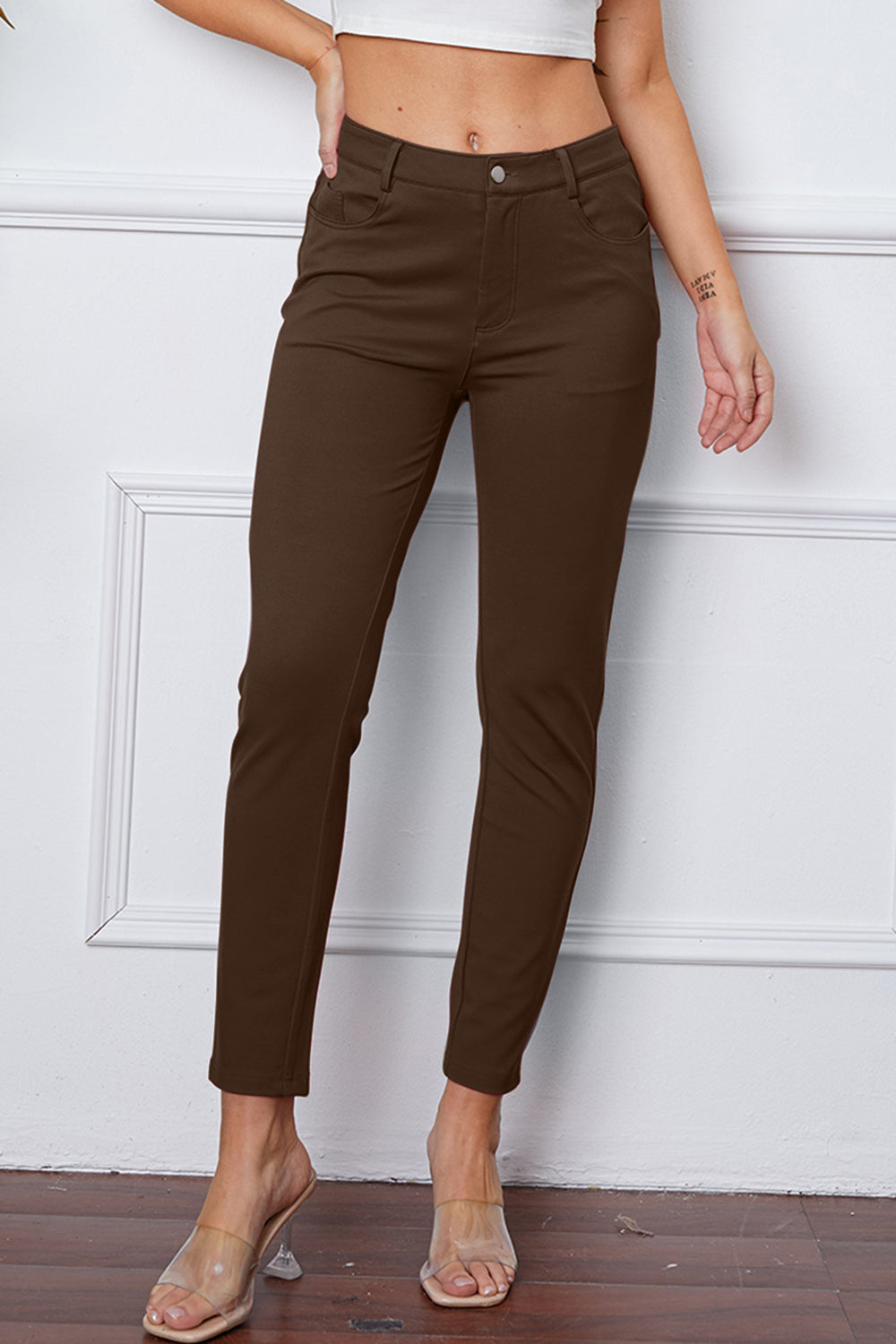 Coffee Brown stretchy high-waisted pants feature pockets, a zip fly, and belt loops. 