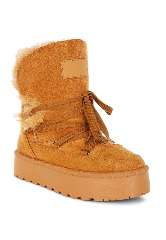 Side view of Tan Noaya Chunky Faux Fur Snow Boots showing flatform heel and lug sole.