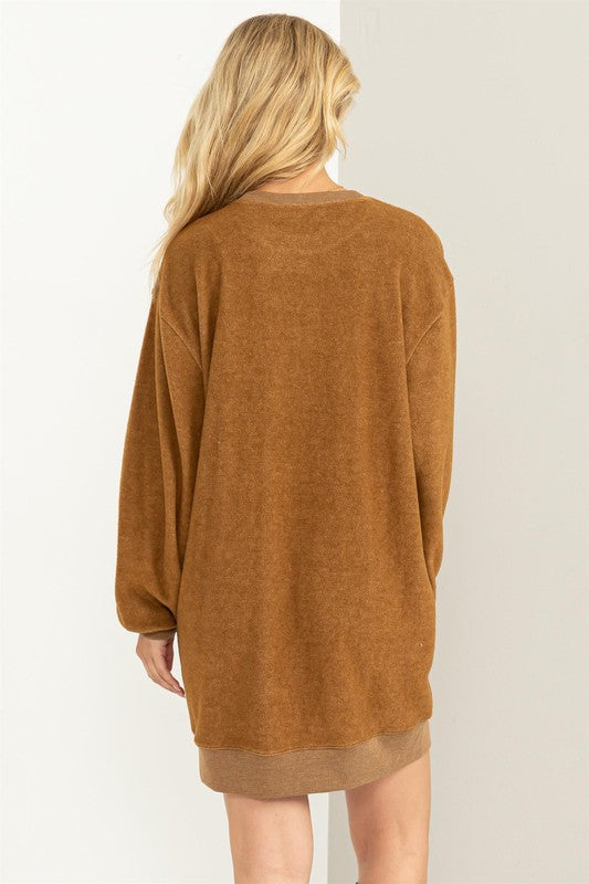 Pale brown girlfriend sweatshirt mini dress with a crew neckline and cuffed hem, drop shoulders, long sleeves, and a relaxed fit. 