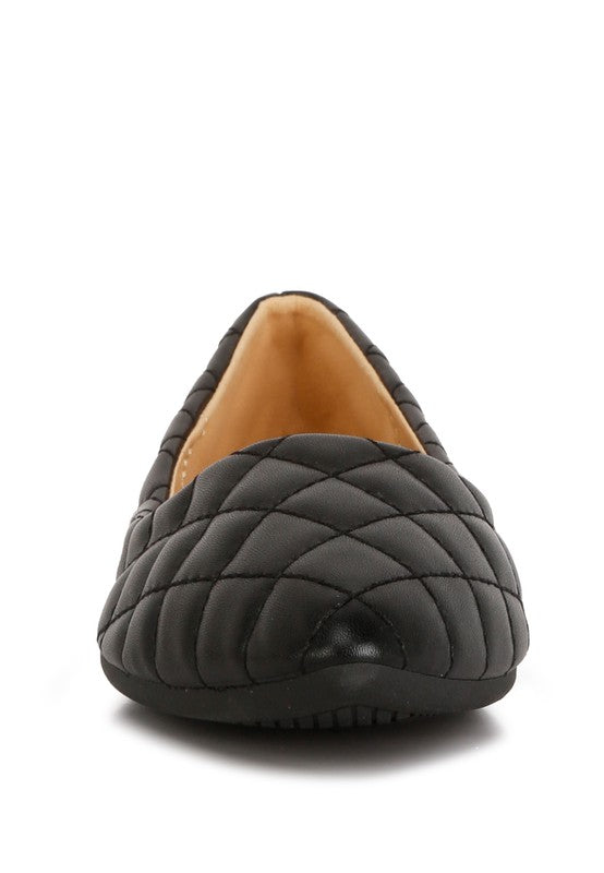 Front view of black quilted ballet flats highlighting quilted pattern.