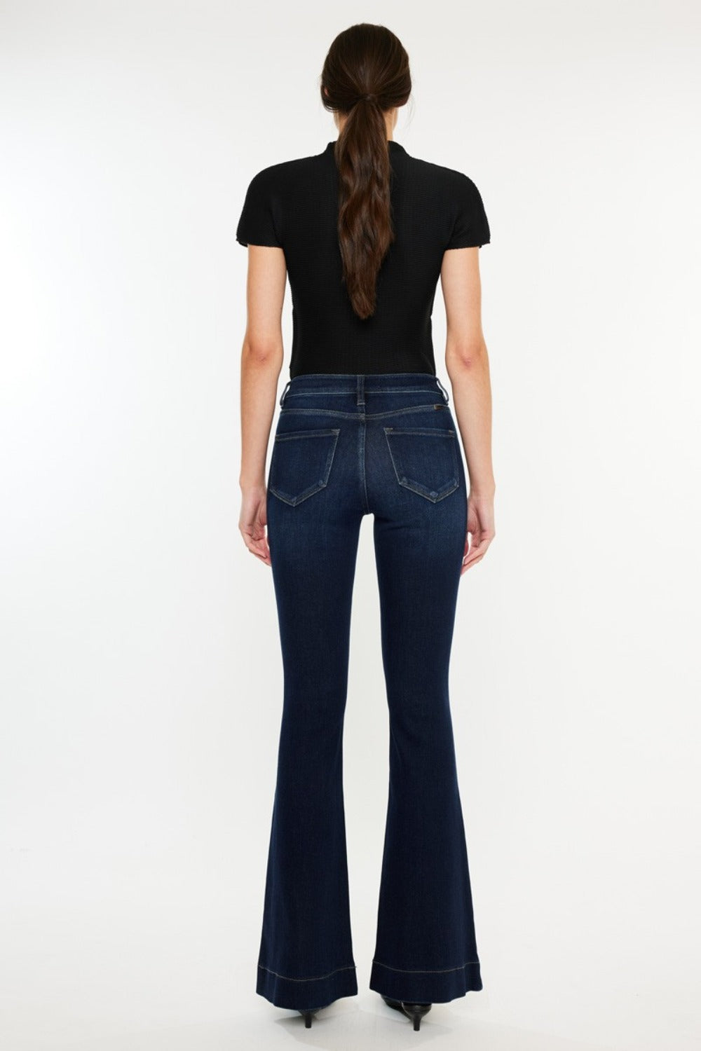 High Rise Slim Flare Jeans by Kancan in dark stone wash, slightly stretchy denim with zip fly. Non-distressed, versatile style for casual or dressed-up looks.