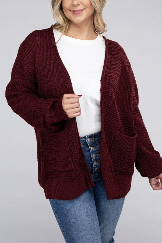 Curvy plus-size waffle-pattern open cardigan sweater in dark burgandy, with long sleeves, oversized fit, and pockets.