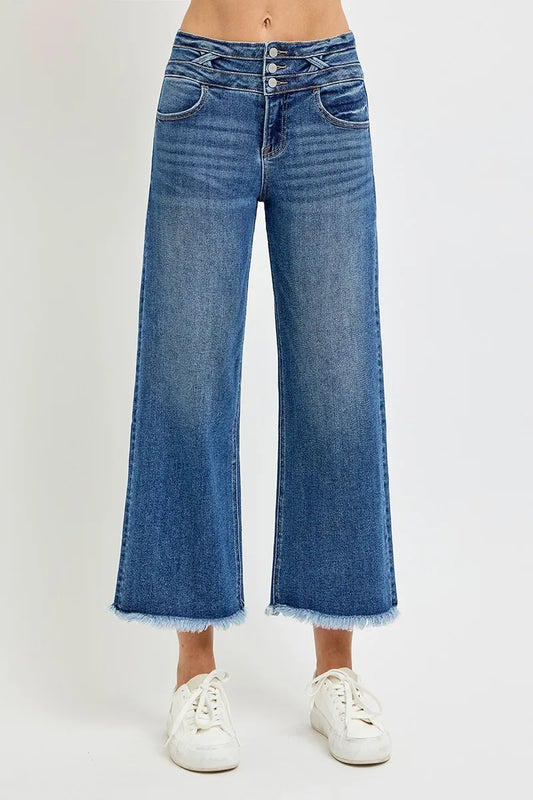 Dark wash wide leg crop jeans with wide band waist and raw hem detail.