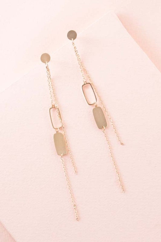 Geometric dangle earrings with sterling silver posts, 4-inch drop, and 0.25-inch width.