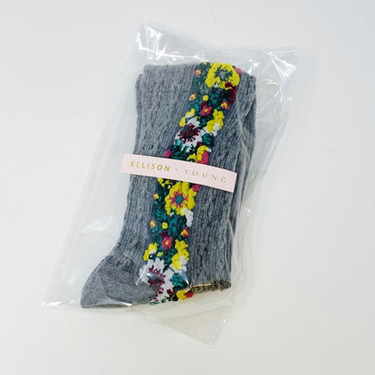 Packaged gray Noble Floral Beauty Socks in clear cello bag with Ellison + Young logo sticker.