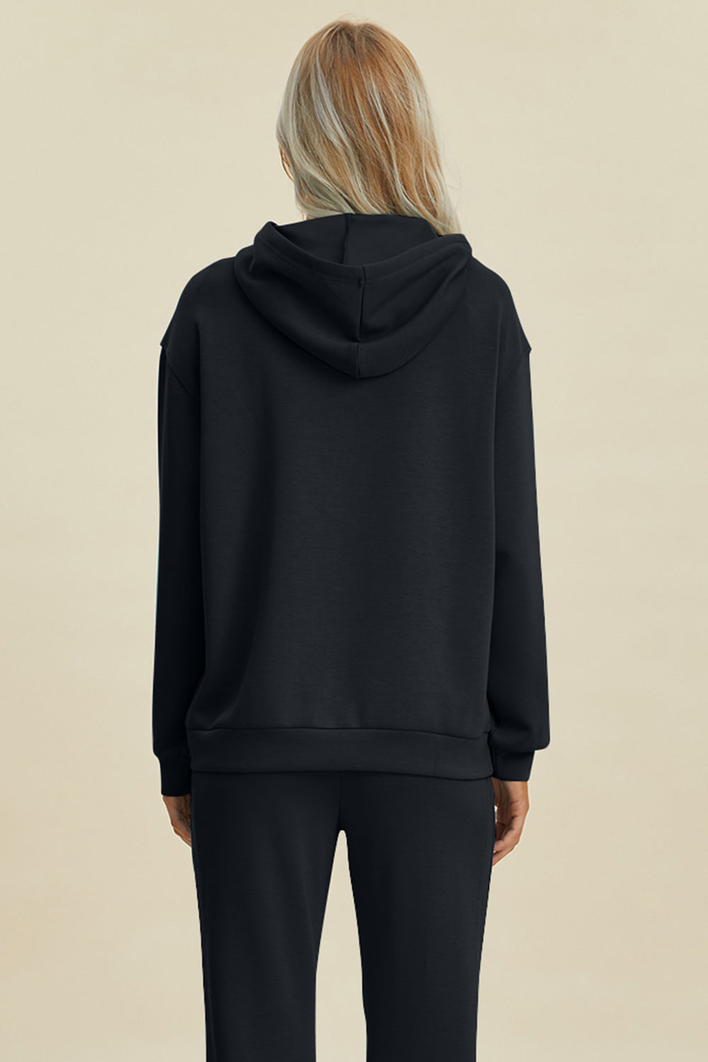 Black long sleeve hoodie with kangaroo pocket, featuring a drawstring hood andrelaxed fit.