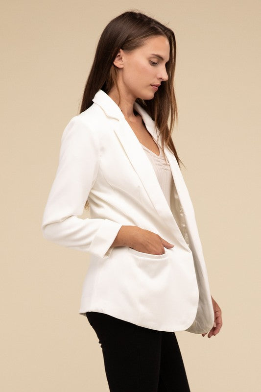 Ivory woven blazer with a lapel neckline, long sleeves, and an open-front design. Features front pockets and a regular fit.