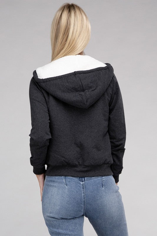 Charcoal cropped zip-up hoodie with fuzzy trim, pockets, and long sleeves.